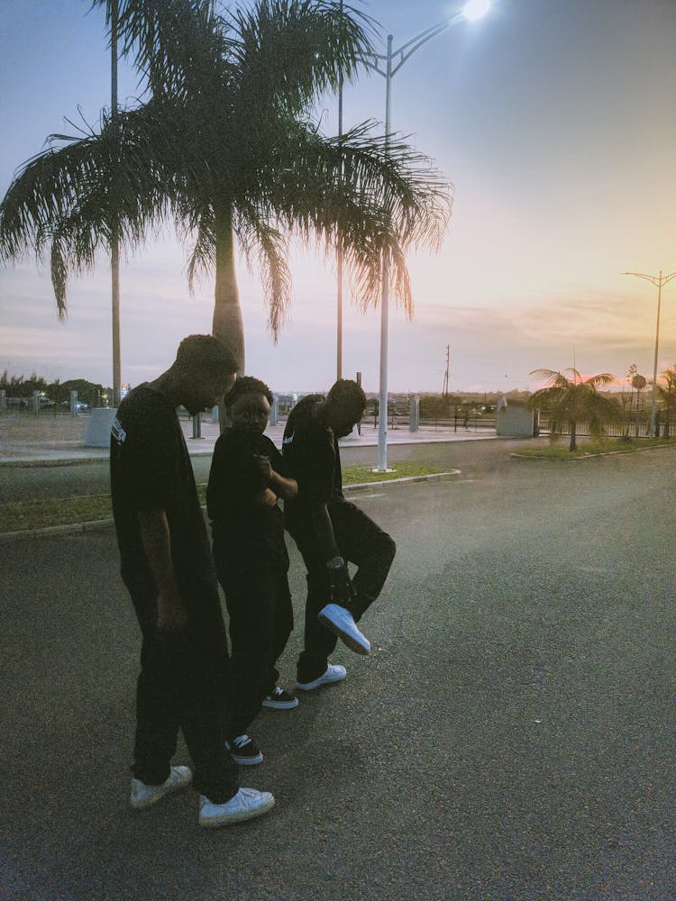 People Looking At The Sunset On The Beach