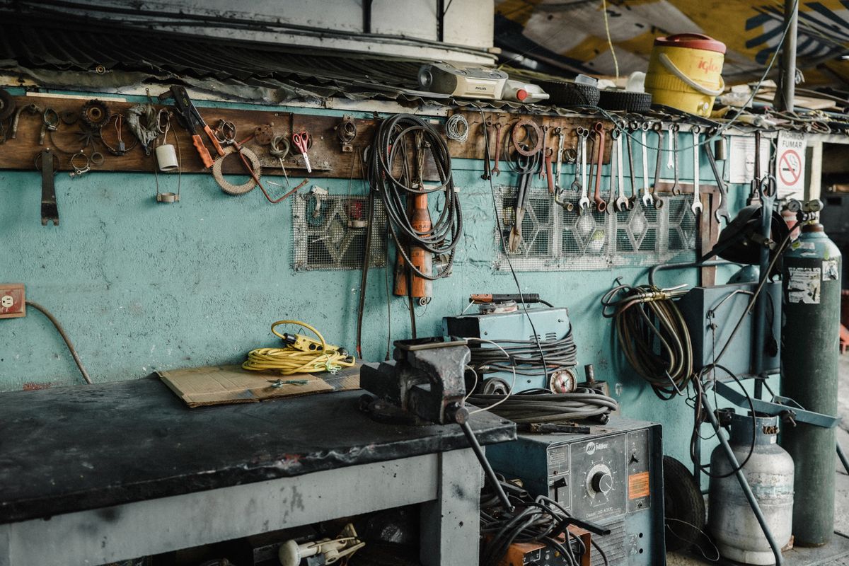 Organized home garage workbench with hand tools and pneumatic air tools laid out for DIY projects
