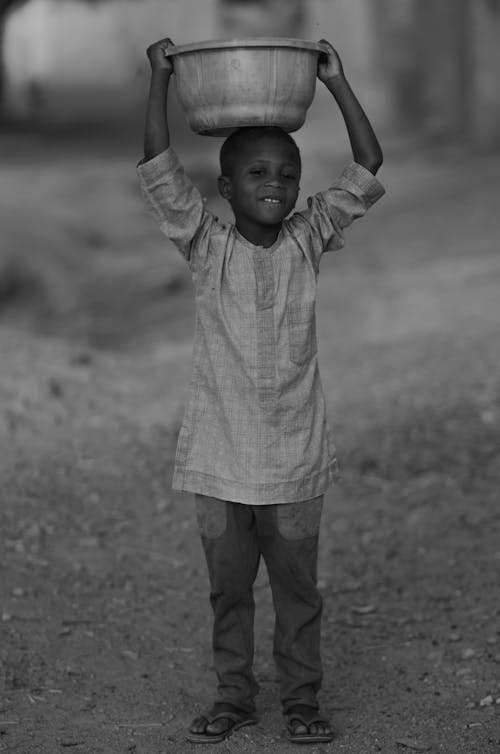 Boy Holding Bowl on Head