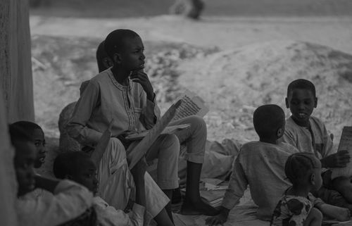 Free A group of children studying outdoors in Nigeria, reflecting cultural education. Stock Photo