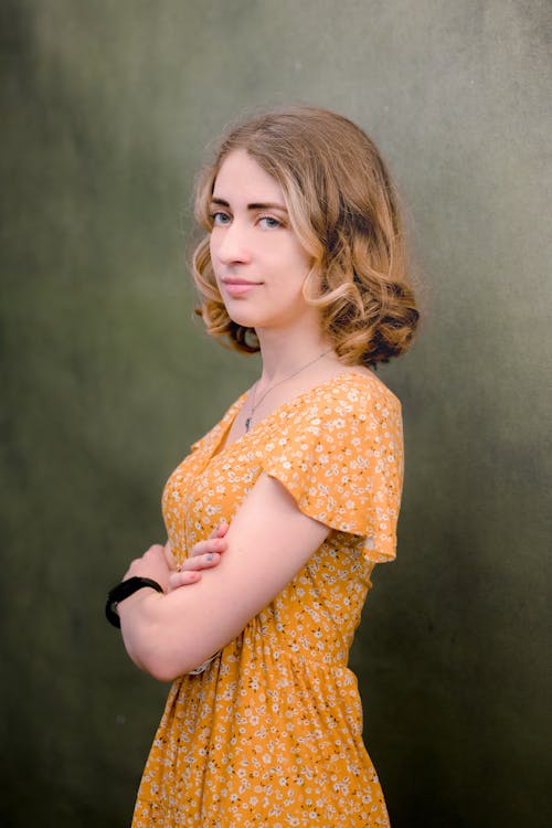 Woman in Orange Dress with Floral Pattern