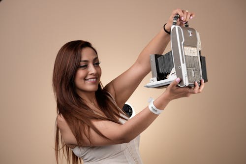 Woman Taking Selfie with Retro Camera