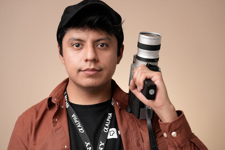 Portrait Of Young Man With Professional Camera 