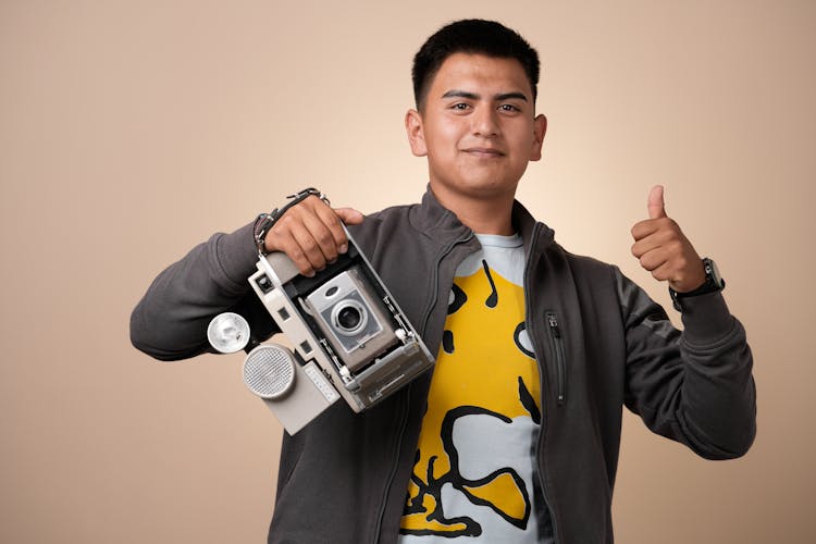 Man Standing And Posing With Camera