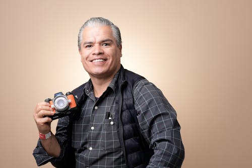 Portrait of Smiling Man Holding Camera