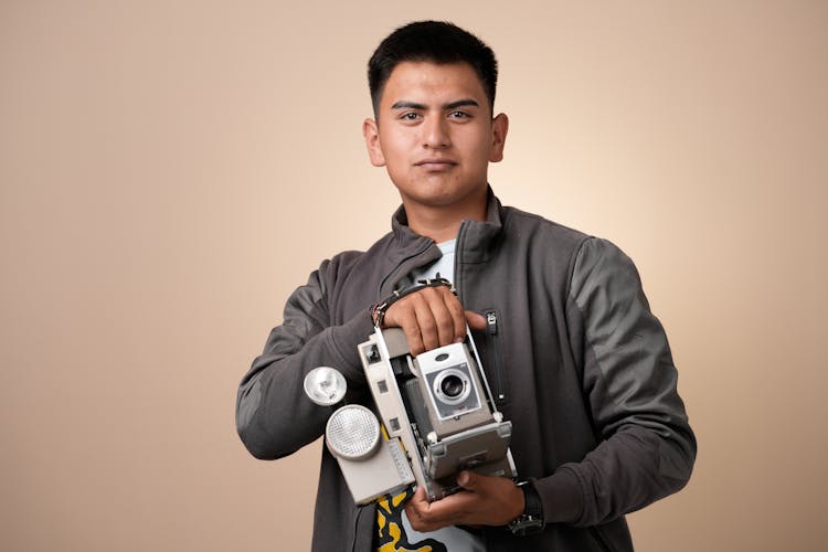 Portrait Of Man Holding Analog Cam