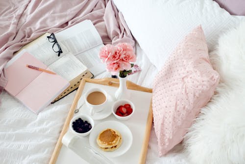 Free Breakfast on Wooden Tray in Bed Stock Photo