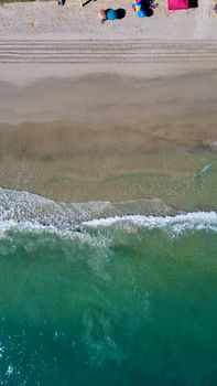 Aerial view of a serene beach in Santa Catarina, Brazil with turquoise waves and sandy shores.