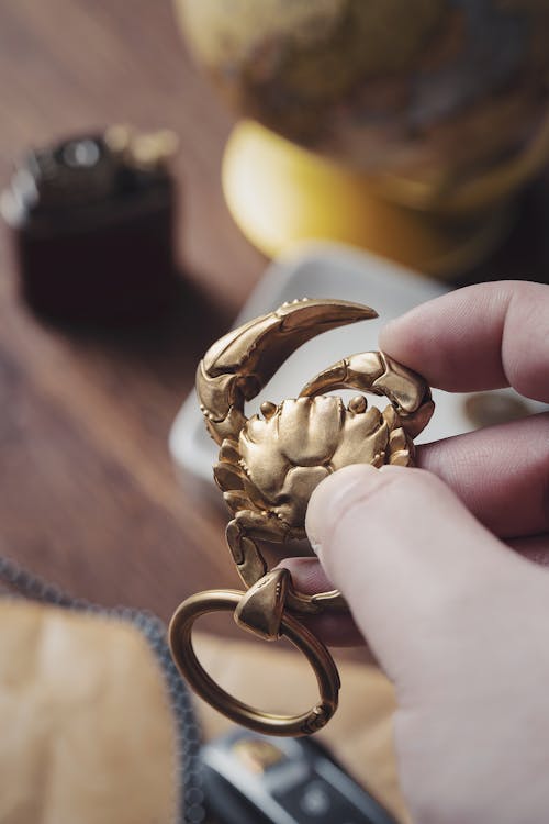 Free Man Holding a Golden Heart Shape Key Ring  Stock Photo