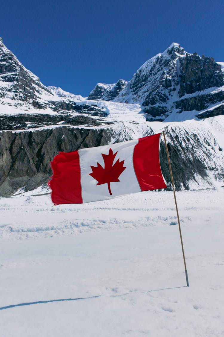 Canadian Flag In A Mountain Valley 