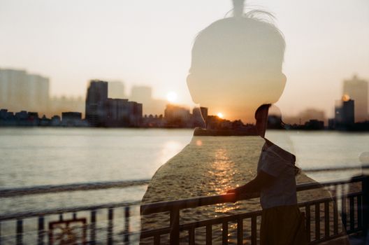 Silhouette of a Man on a Photo of a Woman Smiling on a Bridge