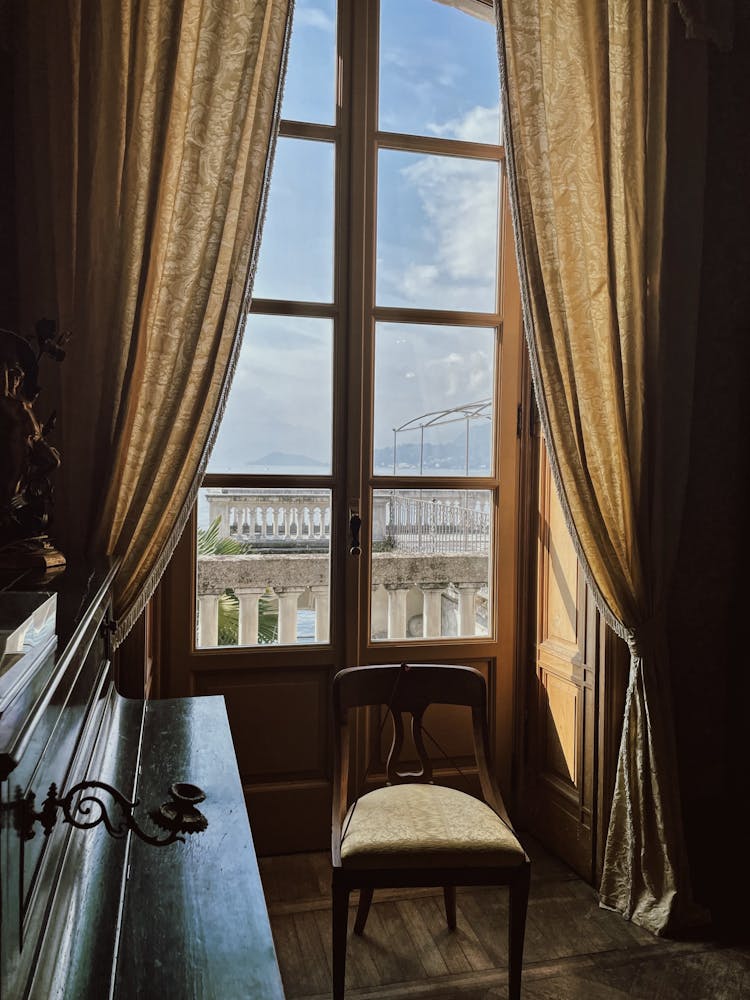 Window With Curtains In Old Luxury Mansion