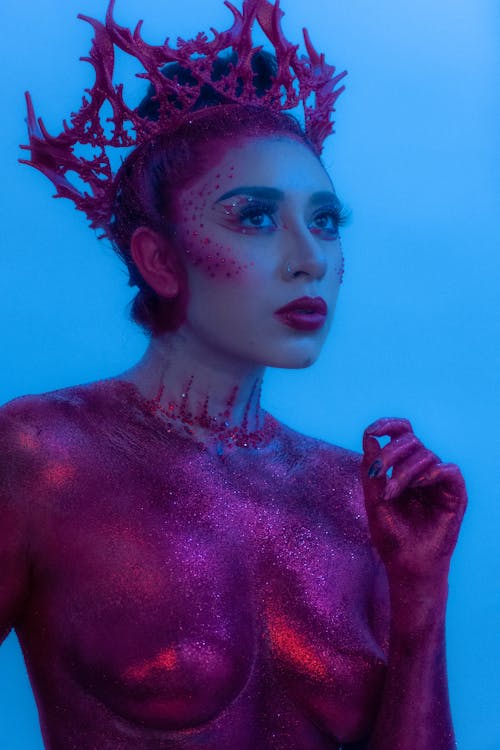 Woman in Eccentric Costume on Blue Background