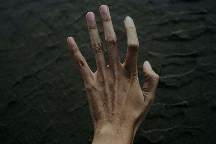 A Human Palm On A Dark Background