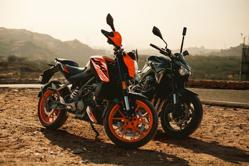Free Two motorcycles parked outdoors in a rural desert area under sunny weather, showcasing adventure potential. Stock Photo
