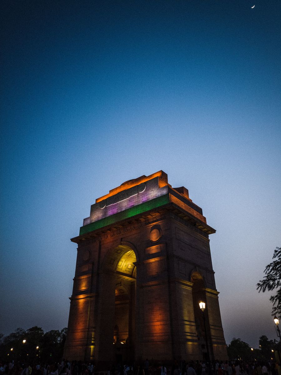 India Gate in New Delhi illuminated against the twilight sky