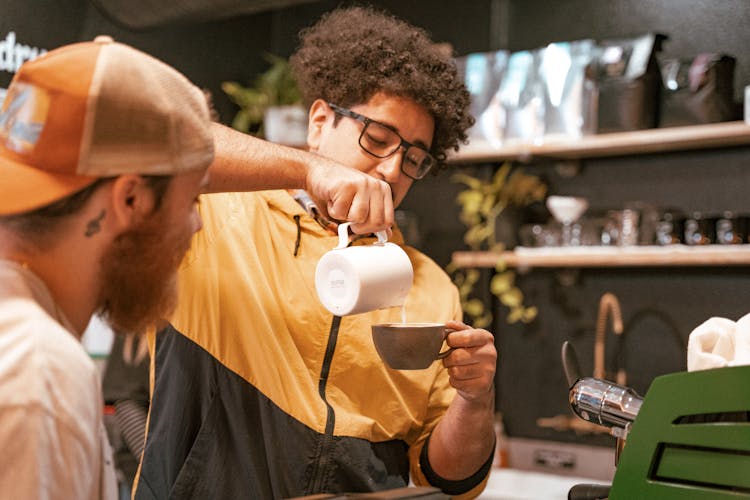 Man Making Coffee In Cafe