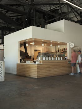 Modern coffee shop counter with sleek design inside an industrial-style cafe.
