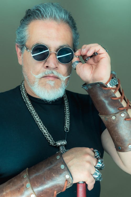 Gray Haired Man in Bracers and Sunglasses