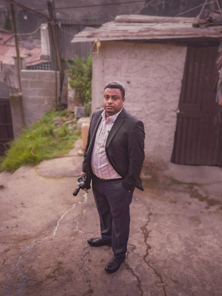 Man In Suit Standing On Town Street