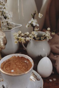 Elegant coffee setup with delicate flowers and a cozy atmosphere, perfect for creative inspiration.