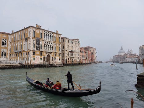 Gondola ride on the Grand Canal with Venetian architecture in Venice, Italy.