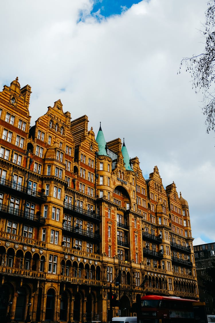 Traditional Old Apartment House Facade Against Blue Sky