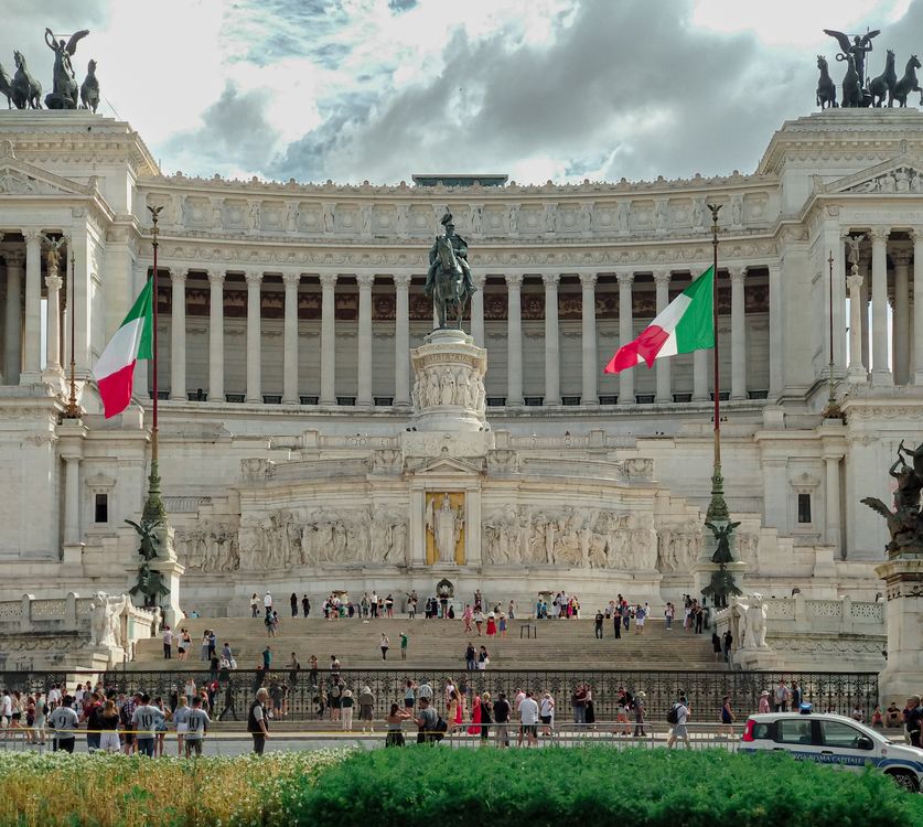 Collusem Rome Flag The roman colosseum is surrounded by many flags · Free Stock Photo