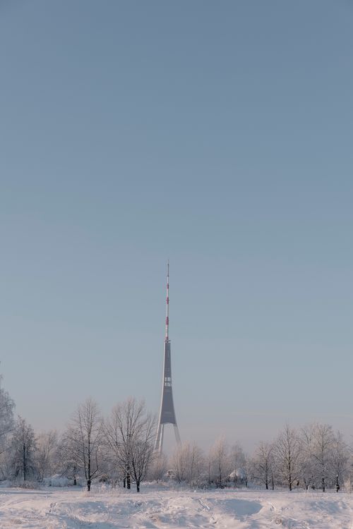 Free Tall transmission tower in a frosty winter landscape under a clear blue sky. Stock Photo