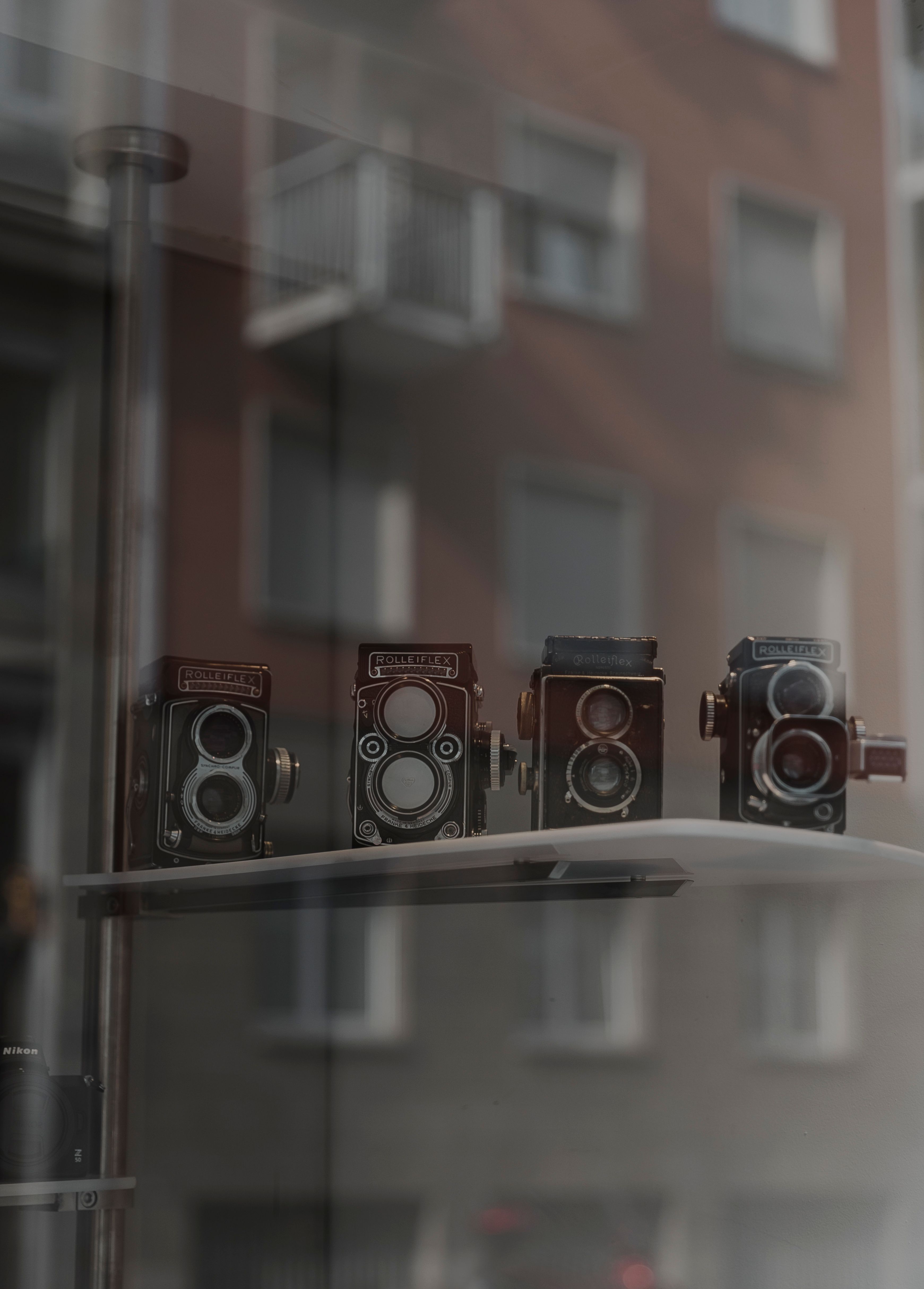 Vintage Cameras on Display in Store Window · Free Stock Photo