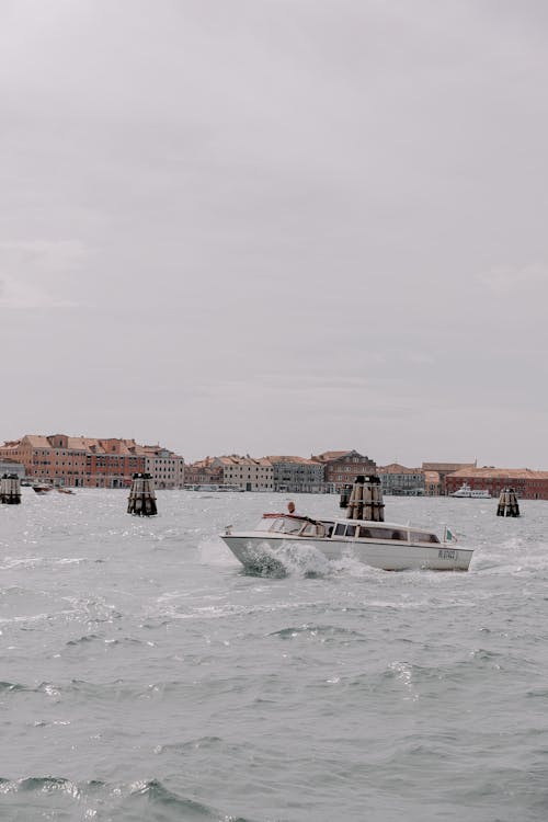 Motorboats on Sea with Town behind