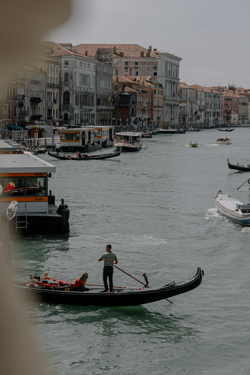 Free Gondolas cruising the scenic Canal Grande in Venice, showcasing traditional architecture. Stock Photo