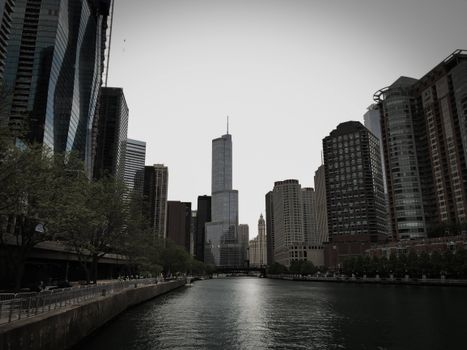 Dramatic view of modern skyscrapers along the Chicago River in an urban setting.