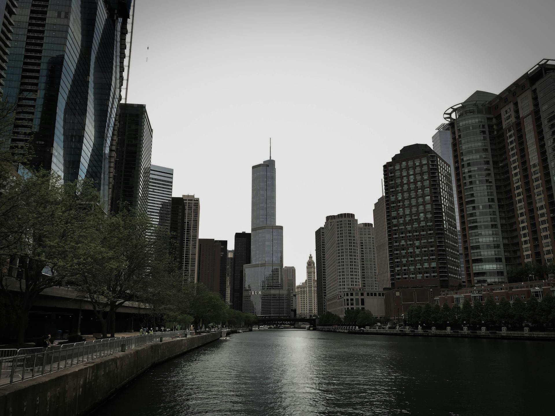 Dramatic view of modern skyscrapers along the Chicago River in an urban setting.