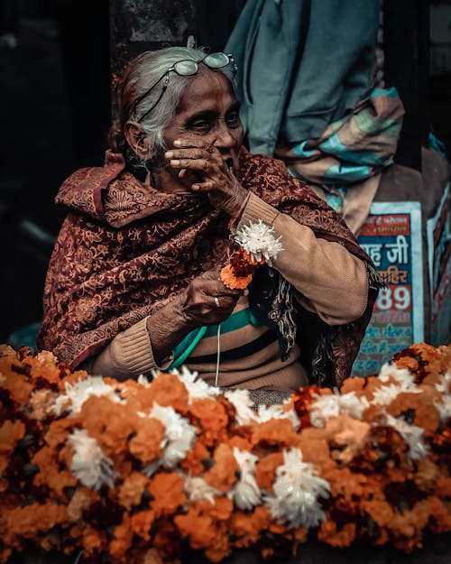 Elderly Woman Sitting with Flowers