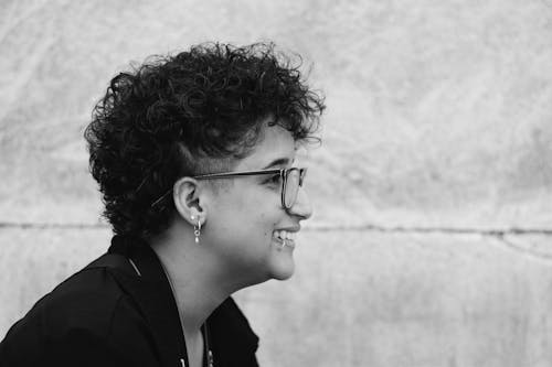 Free Side View of a Young Woman with Short Hair and Eyeglasses Stock Photo