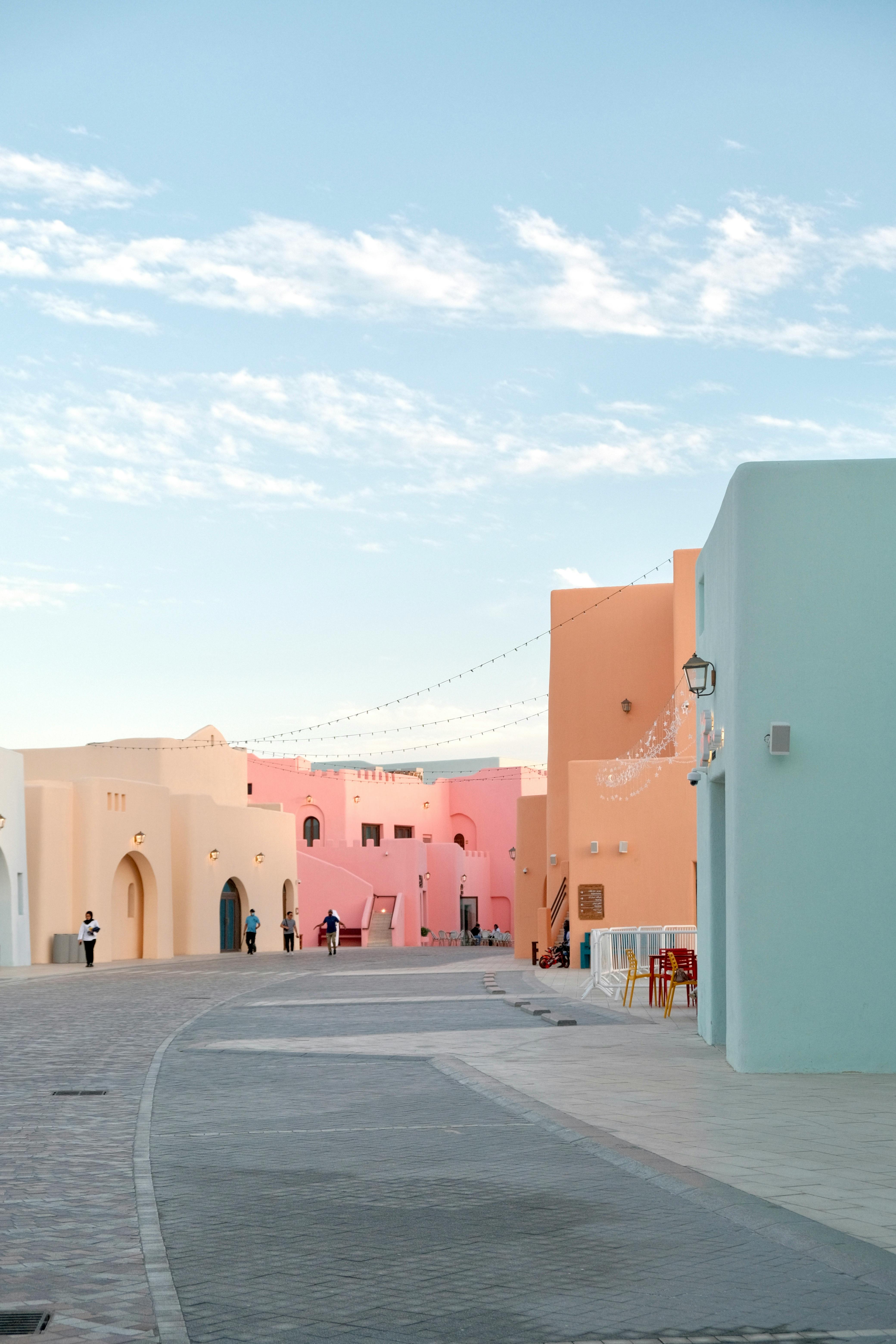 Vibrant pastel buildings lining the street in Katara Cultural Village, Doha, Qatar.
