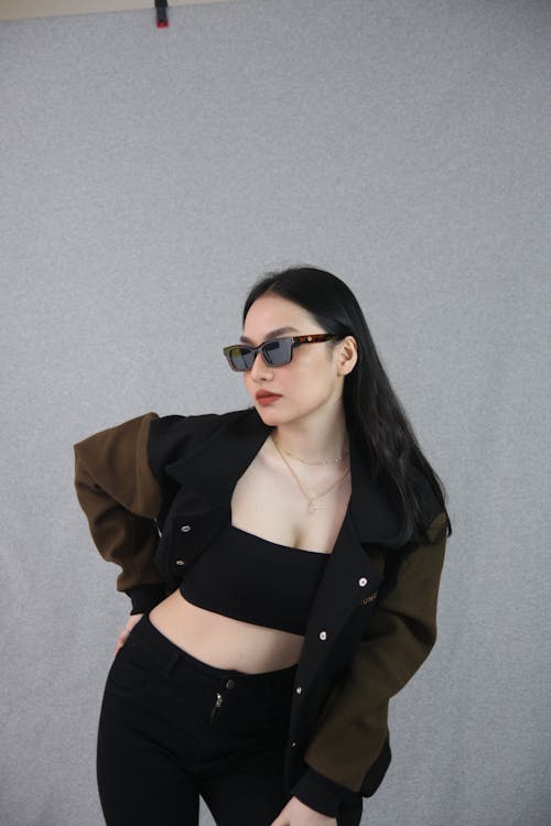 Young Woman in a Trendy Outfit and Sunglasses 