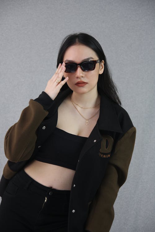 Young Brunette in Sunglasses and a Casual Trendy Outfit 