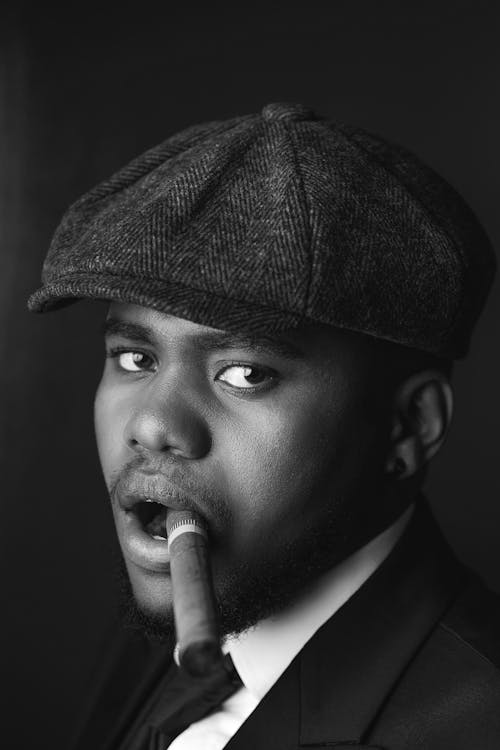 Free Man in a Peaked Cap Smoking a Cigar  Stock Photo