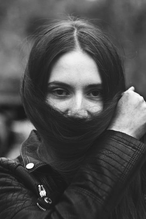 Portrait of Woman Covering Face with Long Hair