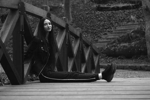 Woman Sitting and Posing on Wooden Footbridge