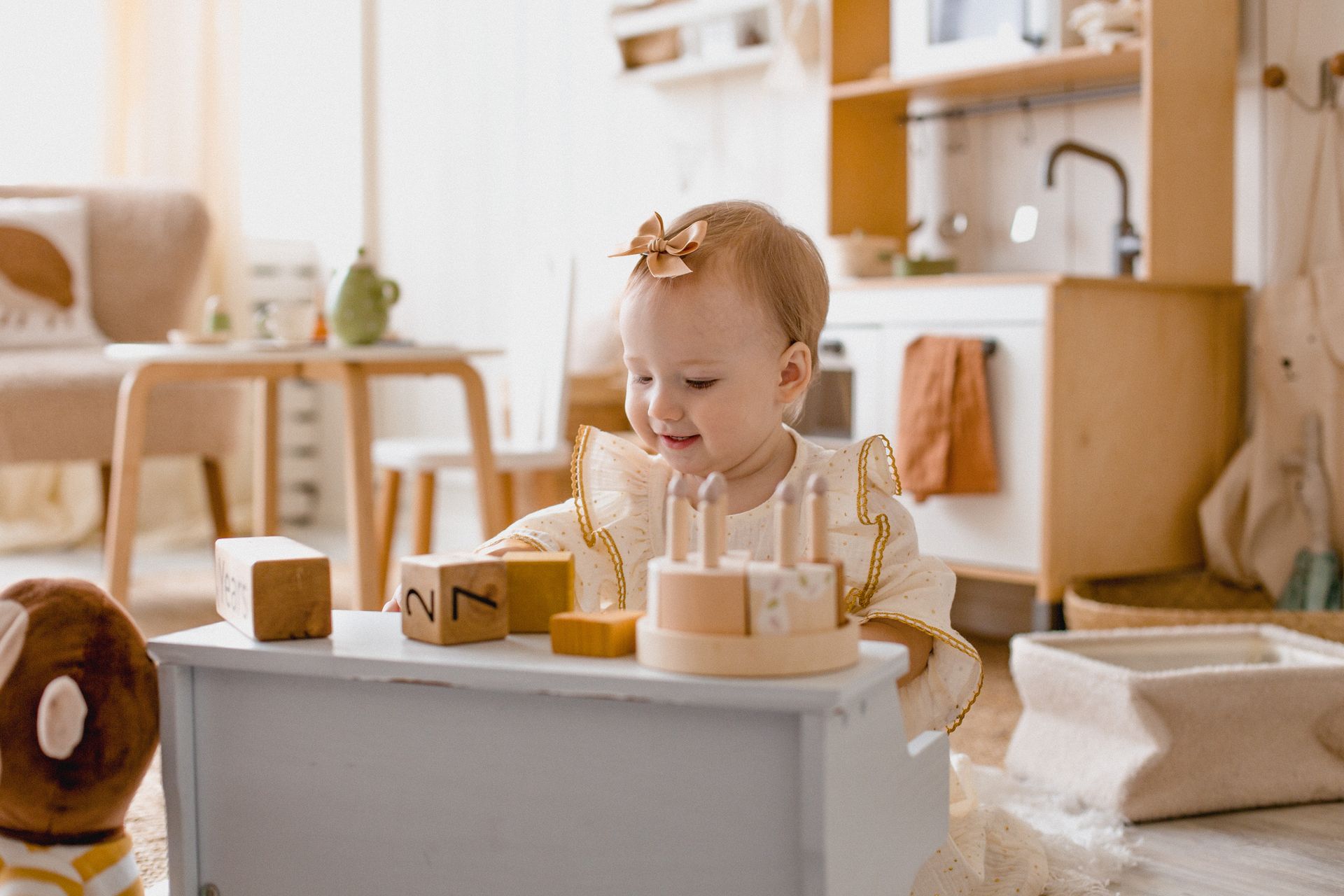 Cute baby in a cozy room playing with educational wooden blocks, enjoying a playful and learning environment.