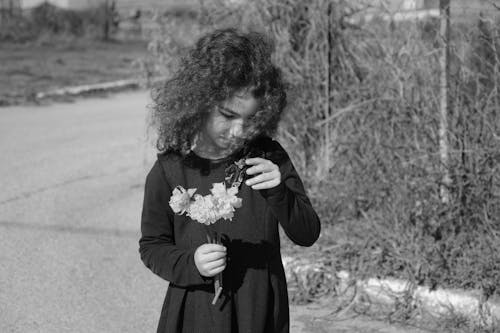 A Girl Holding Flowers 