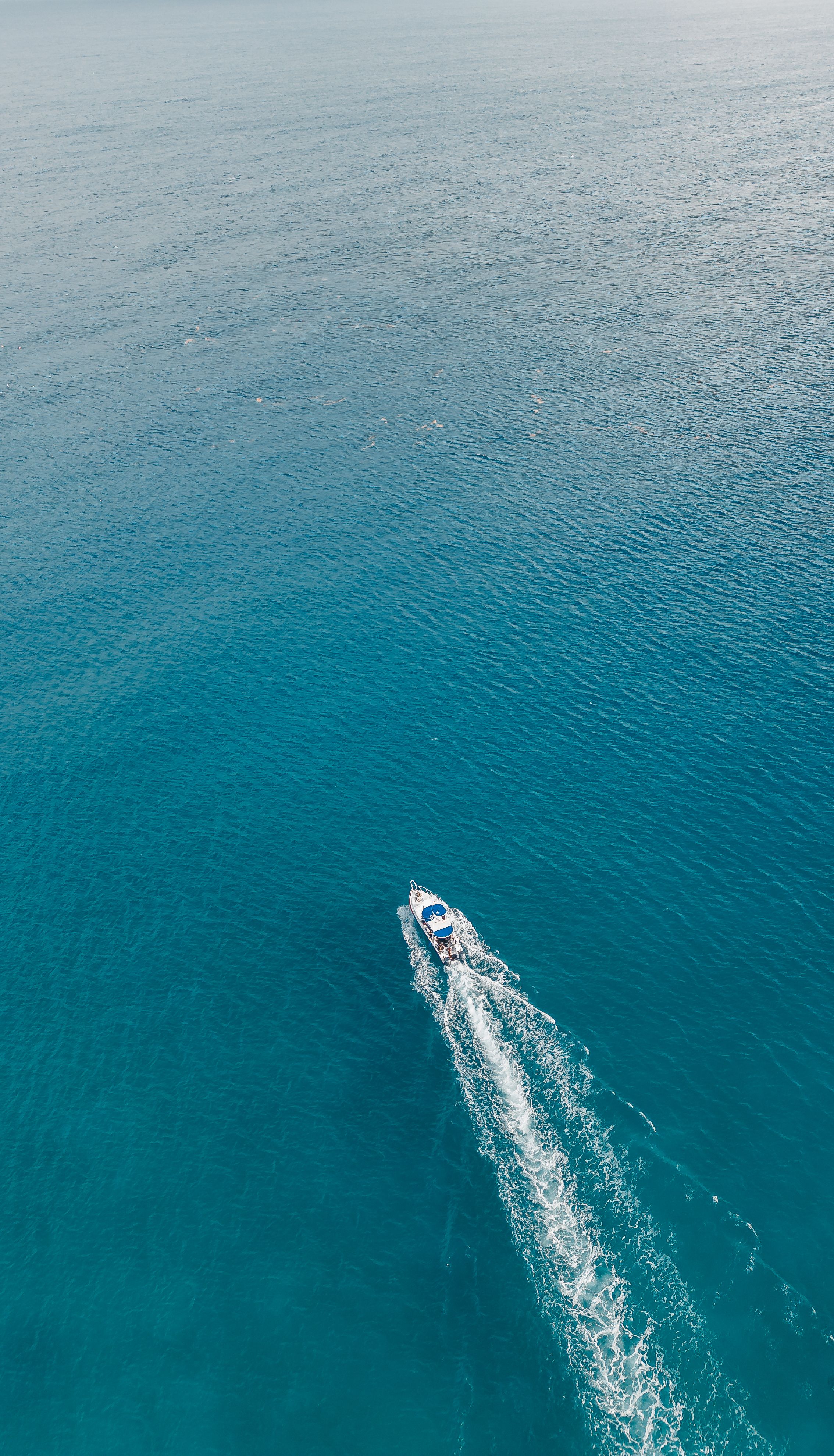 Tour boat crossing turquoise water off Playa del Carmen, illustrating how Mexico tour prices are advertised