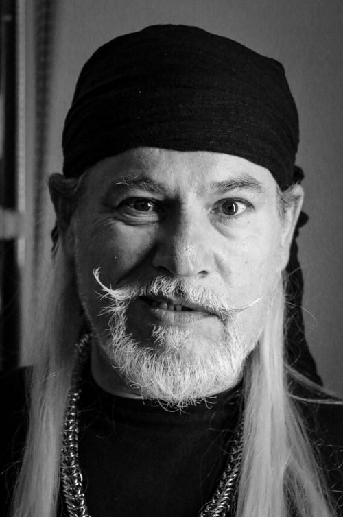 Free A striking black and white portrait of a bearded man wearing a headscarf, showcasing intricate details. Stock Photo