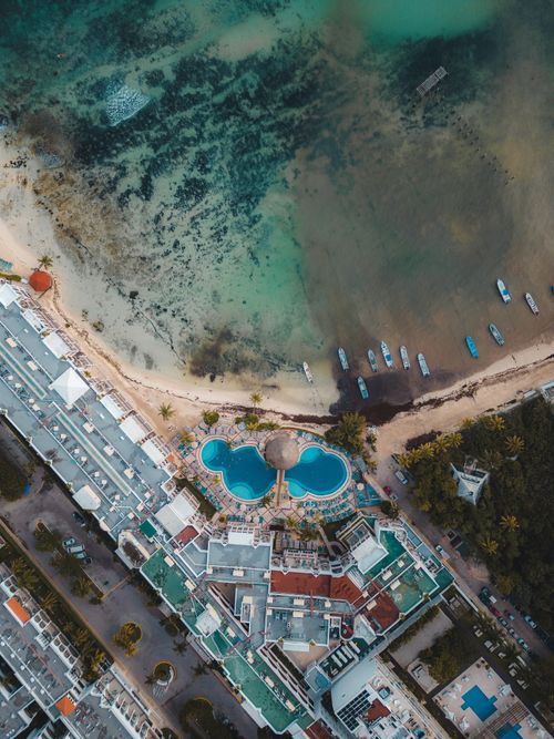 Free Stunning aerial view of a resort by the coast in Playa del Carmen, showcasing clear waters and serene beaches. Stock Photo