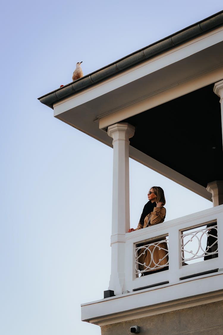 Woman Standing On A Balcony 