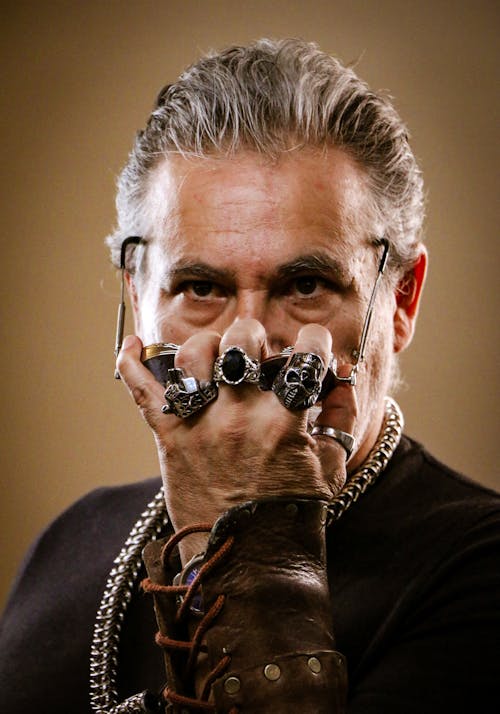Face of Man with Rings on Hand
