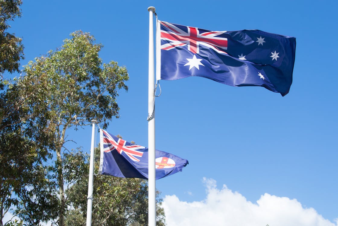 Free Australia flag with New South Wales (NSW) state flag in the background Stock Photo